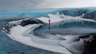 Glacier man red jacket umbrella - environmental art free wallpaper for desktop