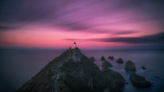 Lighthouse rocky cliff purple sunset - a rocky cliff free wallpaper