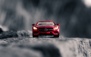 Red toy car rock tiltshift - a rock surface free wallpaper