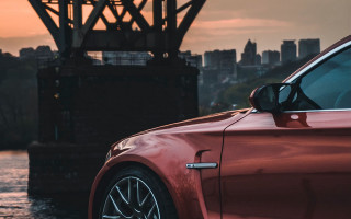 Red car bridge city sunset - a red car free wallpaper