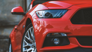 Red mustang headlights grill building - a building in the background free wallpaper for desktop