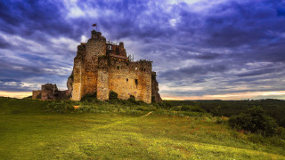 Castle hillside medieval ruins cloudy - a green field below free wallpaper