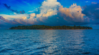 Small island ocean cloudy sky - the water below free wallpaper for desktop