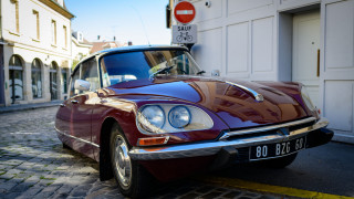 Red car parked road building - les automatiste free wallpaper