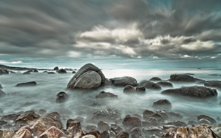 Rocky beach large rock cloudy - a large rock in the middle of it free wallpaper