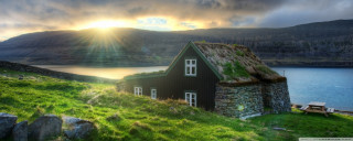 Grass roof house lake mountains - a sunbeam free wallpaper