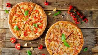 Two pizzas wooden table tomatoes - the table top free wallpaper