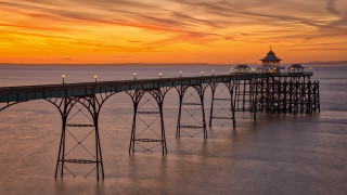 Pier lights sunset ocean lighthouse - a lighthouse in the distance free wallpaper