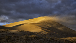 Sand dune cloudy sky bushes - a large sand dune free wallpaper
