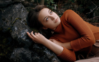 Woman leaning rock aurora starry - a forest in the background free wallpaper