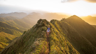 Woman hiking mountains sunset nature - a sunset in the distance free wallpaper