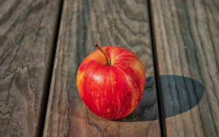 Red apple wooden table shadow 3 - a red apple free wallpaper for desktop