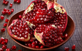 Pomegranates wooden table red fruit - a wooden table free wallpaper