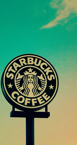 Starbucks sign blue sky clouds - against a blue sky background free wallpaper