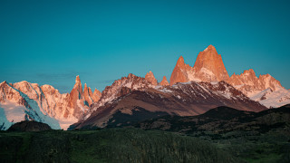 Mountain range snow capped sunset 3 - a few snow free wallpaper