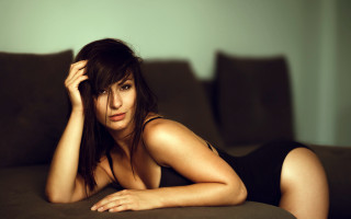 Woman black dress couch laying 2 - livia prima free wallpaper