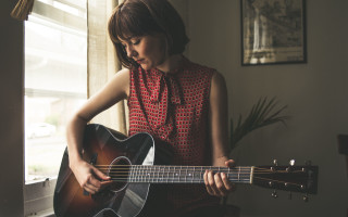 Woman playing guitar room window - a plant in the corner of the room free wallpaper