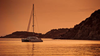 Sailboat rocky shore sunset mountain - rich color free wallpaper