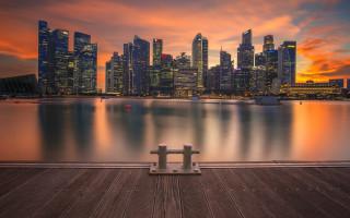 Bench pier city sunset sky - a red sky in the background free wallpaper