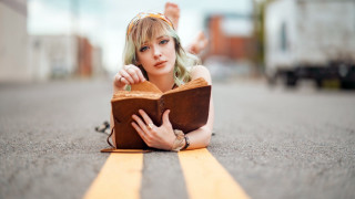 Woman reading blonde portrait bokeh - her face and a hand free wallpaper