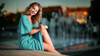 Woman sitting fountain smiling portrait - a fountain free wallpaper