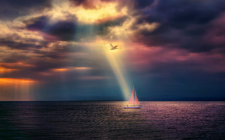 Sailboat cloudy sky light beam - a body of water under a cloudy sky free wallpaper