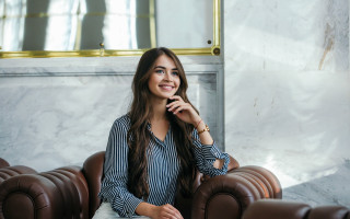 Woman sitting brown leather couch - christian hilfgott brand free wallpaper for desktop