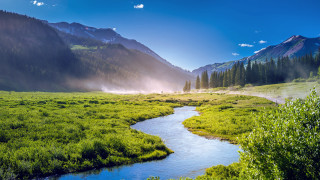 River valley mountains trees sunny 2 - a lush green valley free wallpaper