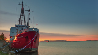 Docked boat sunset mountain water - a mountain in the background and a body of water free wallpaper