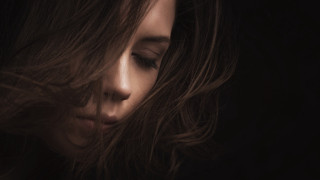 Woman blowing hair portrait dark - a dark room free wallpaper for desktop