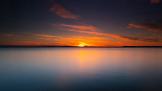 Sunset water boat clouds dusk - a sunset over a body of water free wallpaper