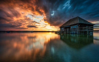 House dock sunset clouds water - a body of water below free wallpaper