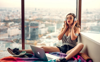 Woman sitting window sill laptop - music free wallpaper