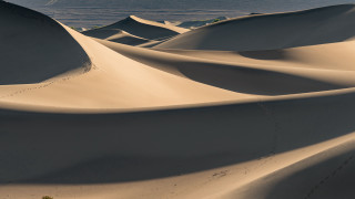Sand dunes water skyline land - the background and a sky line in the foreground free wallpaper for desktop