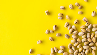Nuts pile yellow background green - product photography free wallpaper