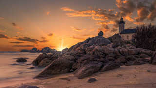 Lighthouse rocky shore sunset clouds 16 - a rocky shore free wallpaper