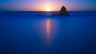Rock ocean sunset bright sky - a rock in the middle of the ocean free wallpaper