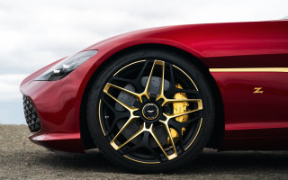 Red sports car gold accents - a gravel road free wallpaper