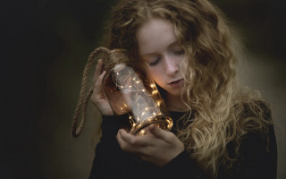 Girl holding glass ball lights - a glass ball free wallpaper
