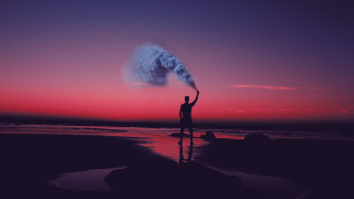 Man beach smoke bomb sunset - a pink sky free wallpaper