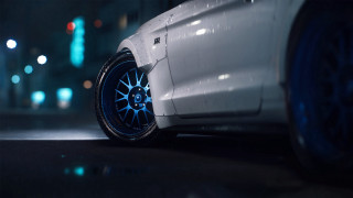White car blue spokes night - cinematic focus free wallpaper