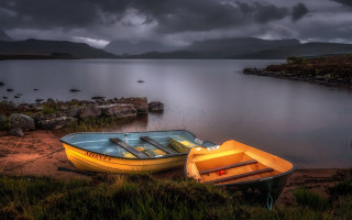 Boats lake beach mountains cloudy - a couple of boats free wallpaper