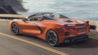 Orange sports car ocean cliffs - a cliff in the background free wallpaper