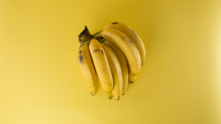Bananas yellow background black stem - ripe free wallpaper for desktop
