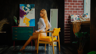Blonde woman chair brick wall - bright studio setting free wallpaper