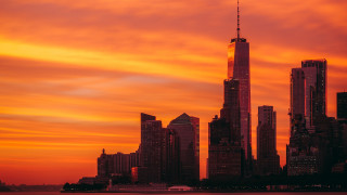 City skyline tower sunset mountain - a red sky in the background free wallpaper