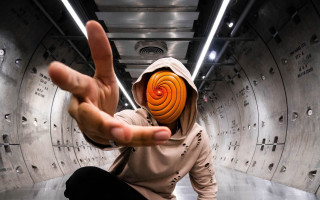 Hooded person spiral face illusion - a finger free wallpaper