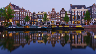 Boats river cityscape night symmetry - tall building and trees free wallpaper