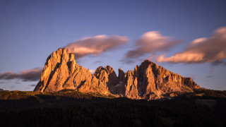 Mountain clouds trees sunset volcano - a few tree below free wallpaper