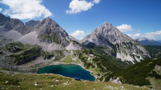 Mountain lake people beach sky - a lake in the middle of it free wallpaper for desktop